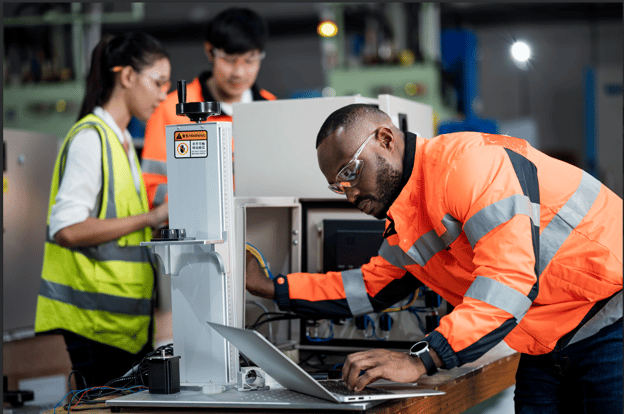 working looking at screen and a machine