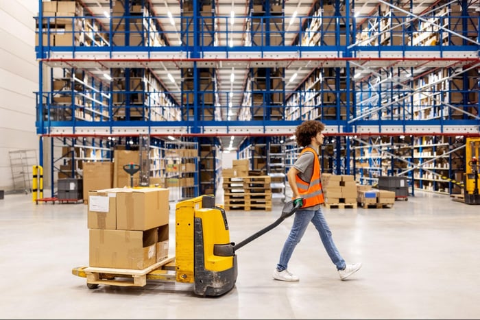 warehouse worker pulling boxes